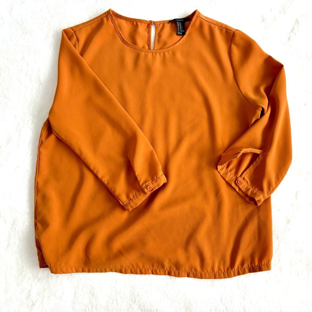Forever 21 rust colored blouse. 3/4 sleeves with button closure.